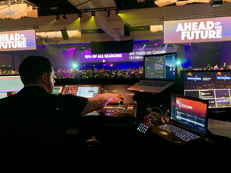 Production team member adjusting the controls on his AV equipment during a live event