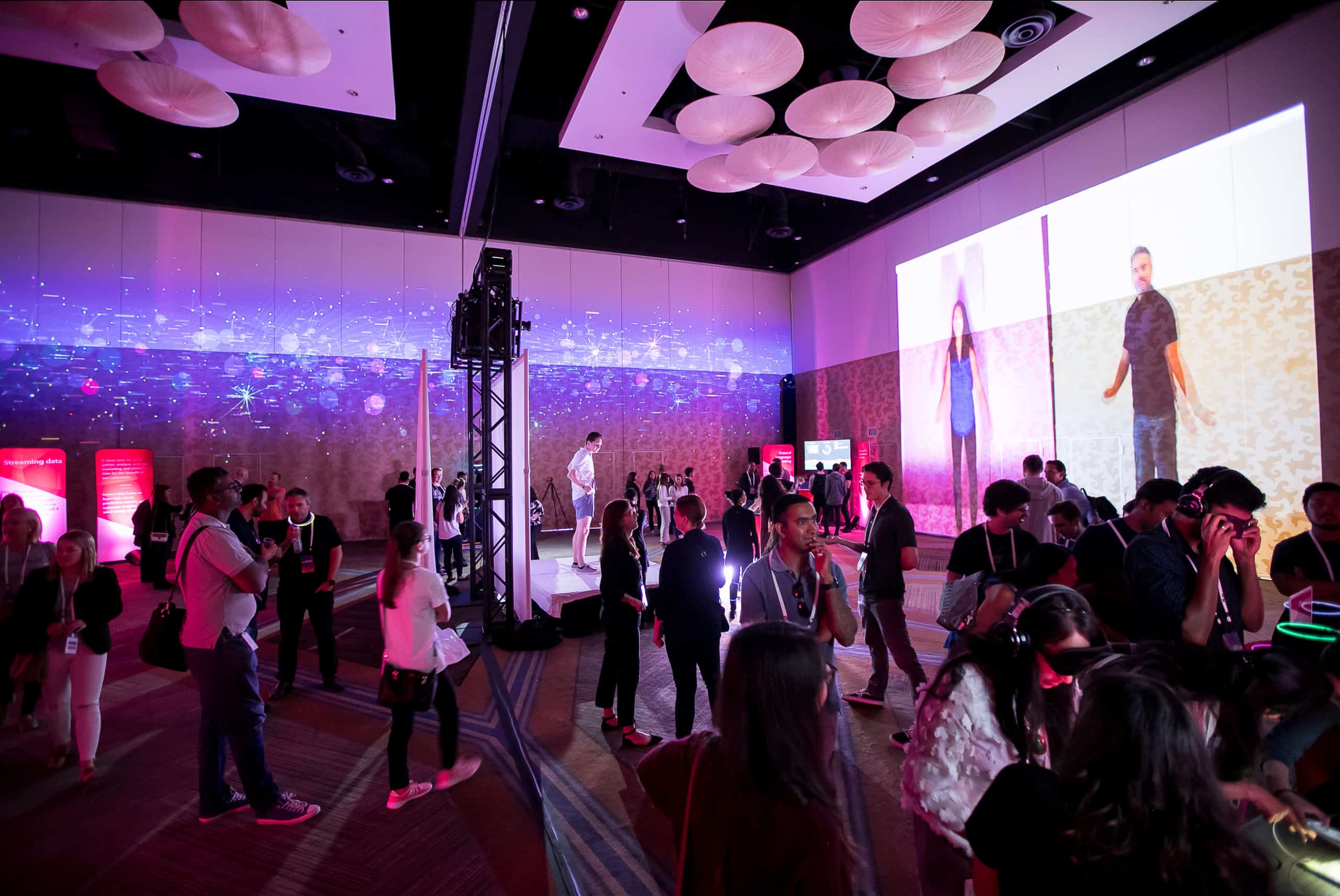 Immersive breakout session area at a financial industry corporate event, showing many attendees interacting with exhibits and networking.