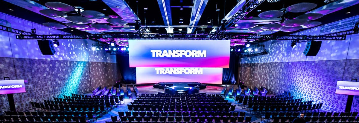 Venue setup for an Intuit Transform event with blue and purple lighting