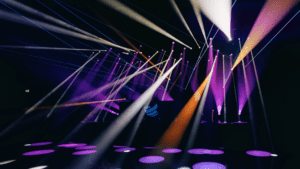 Purple, orange, and white stage lighting designed for a live event venue