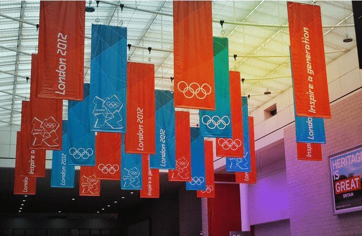 Logo banners of participating companies are rigged on the ceiling of an event venue