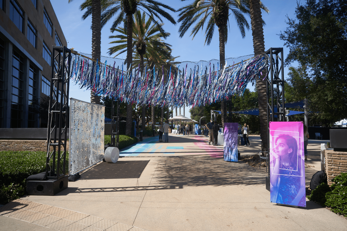 A colorful entrance arch with Intuit branded signage that is an entrance to Intuit's Brand New Day All Hands Meeting in San Diego, California.